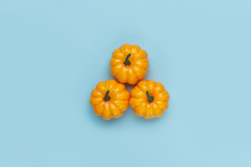 Pumpkins on pastel blue background. Flat lay, top view fall autumn and Halloween concept.