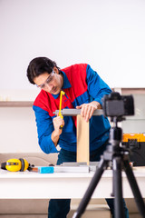 Young contractor recording video for his blog