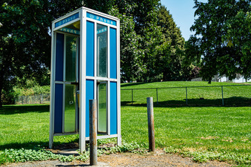 Vintage telephone booth near a public park