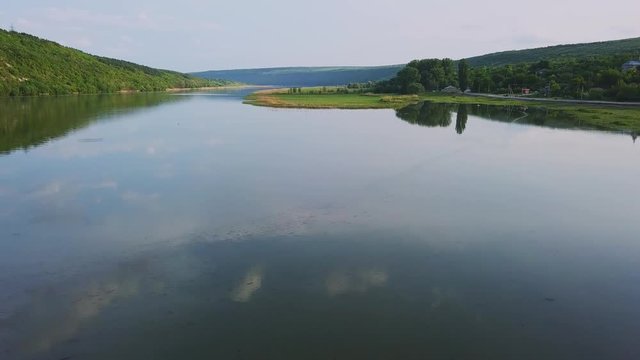 Flying over the river on a sunny summer day. Dniester river of Moldova republic.