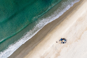 Off road cars and tent on beach in Queensland