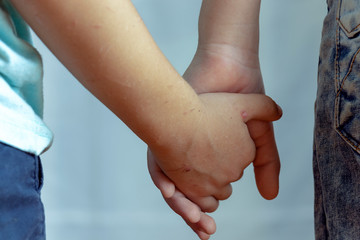 children holding hands close-up
