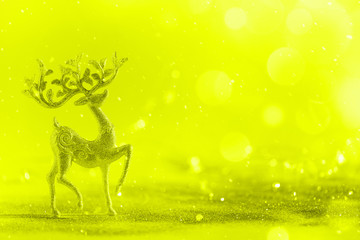 Silver glitter Christmas deer on neon yellow background with lights bokeh, copy space. Greeting card for new year party. Festive holiday concept. Banner