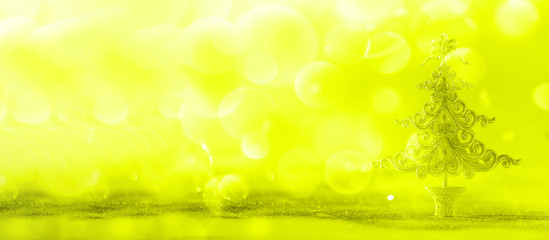 Silver glitter Christmas tree on neon yellow background with lights bokeh, copy space. Greeting card for new year party. Festive holiday concept. Banner
