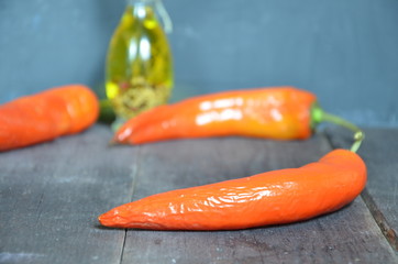 Red hot chili peppers and garlic, on dark wooden background. copy space top view.