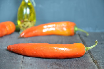 Red hot chili peppers and garlic, on dark wooden background. copy space top view.