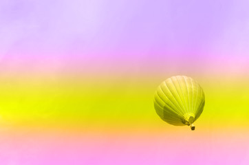 Obraz premium Travel, summer and tourism concept in trendy neon colors. Rainbow gradient background with copy space. Trip, journey background. Blue hot-air balloons flying over sky.