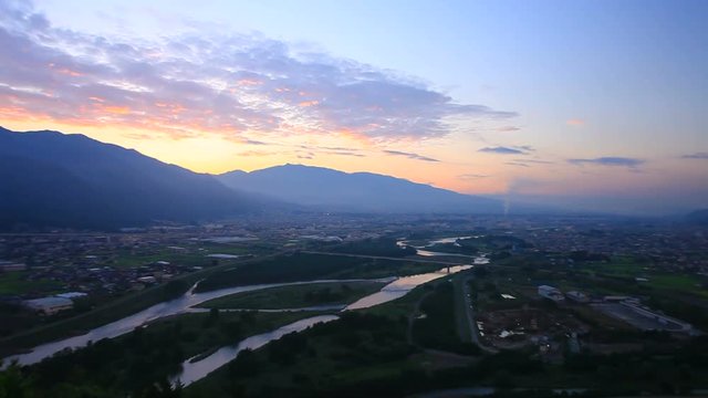 Zoom in of Chikuma River in mountain landscape at sunrise, Japan