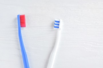 Colorful toothbrushes with selective focus on blurred neutral background. Dental tools for daily...