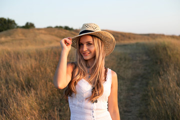 Beautiful woman enjoying nature outdoors at sunset.