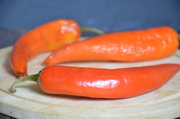 red hot chili pepper corns and pods on dark vintage background, top view