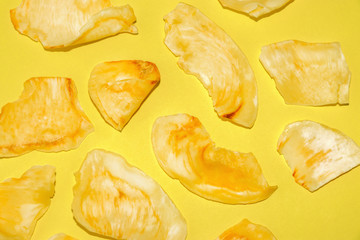 Crispy durian chips on a yellow background, creative flat lay colorful food concept