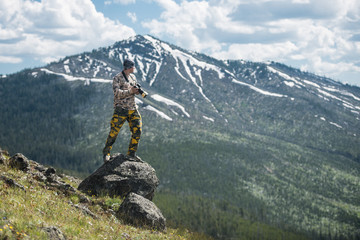 Tourist man photographer taking photos and enjoy the view of mountains in Yellowstone National Park