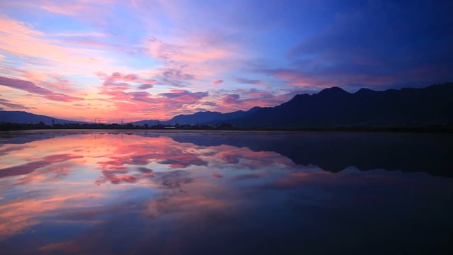 Panning wide shot of mountain reflecting in lake,  Japan