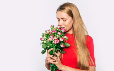 Beautiful woman with big bouquet of roses isolated on white background
