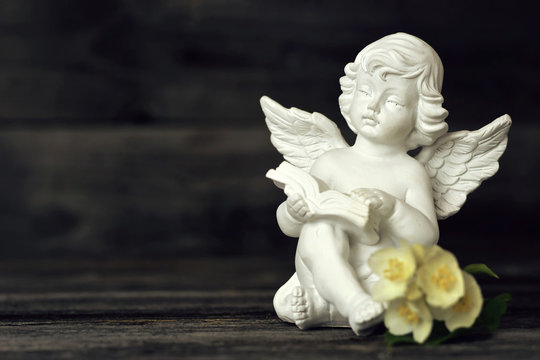 Little guardian angel reading a book