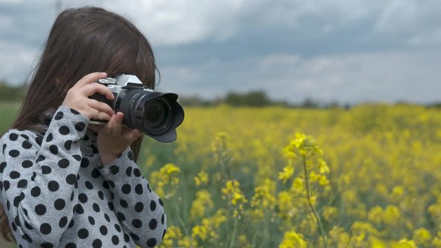 A child in nature with a camera.