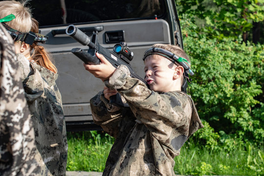 Boy playing in lasertag shooting game, boy with a gun, war simulation.