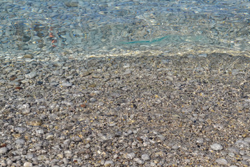 Abstract beach background texture with pebbles, sands and sea water in bodrum turkey