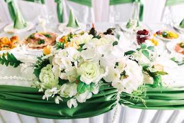 Luxury wedding reception in restaurant. stylish decor and adorning. Restaurant table with food
