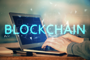 Blockchain theme hud with businessman working on computer on background. Concept of crypto chain. Double exposure.