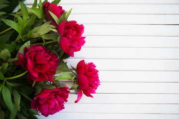 a bouquet of beautiful peonies lies