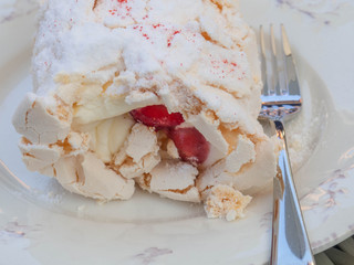 Strawberry pavlova cake on white plate