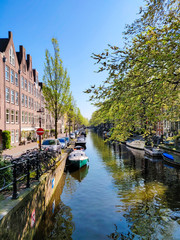 Narrow canal in Amsterdam at spring.