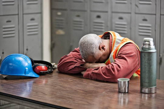 Senior worker taking break in locker room