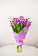 bouquet of beautiful violet lush tulips in a vase