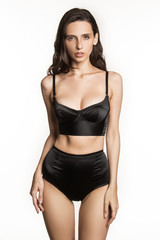 Stunning beautiful dark hair girl stripped in lingerie on white isolated font	