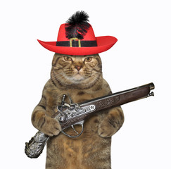 The cat musketeer in a red hat with a feather holds a flintlock pistol. White background. Isolated.