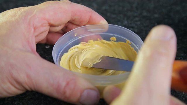A man dilutes the putty on the metal hardener and mixes it
