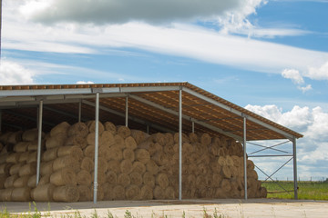 Winter stocks. The hay storage shed full of bales hay on farm. © Vasiliy Ulyanov