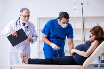 Two doctors examining young woman