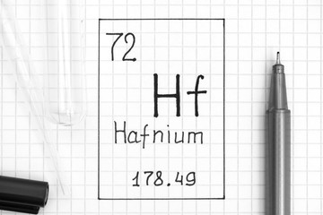 The Periodic table of elements. Handwriting chemical element Hafnium Hf with black pen, test tube and pipette.