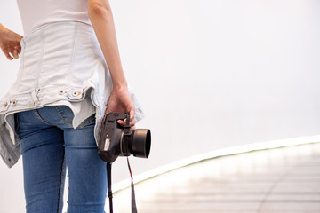 A beautiful young photographer with photographs in the city and in different angles. Other, shapely girl, teen