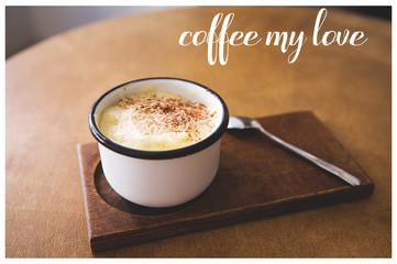 a cup of cappuccino stands on a wooden table, the inscription of coffee my love