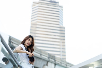 A beautiful young photographer with photographs in the city and in different angles. Other, shapely girl, teen
