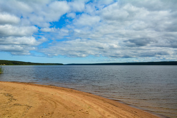 Yellow sandy shore near a big lake