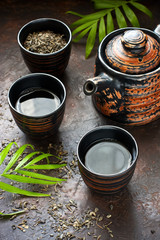 Asian green tea with small pot and cups