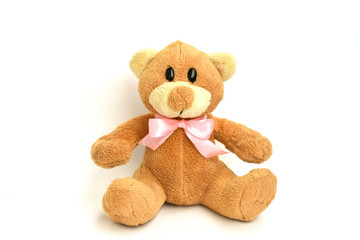Baby bear toy with pink bow on white isolated background