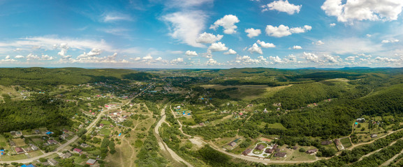 Drone aerial view large panorama - a small village in the foothills of the western Caucasus.