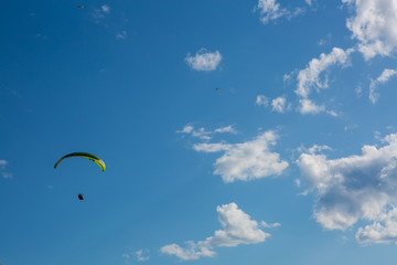 paraglider flying in the blue sky. Paragliding