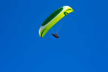 paraglider flying in the blue sky. Paragliding