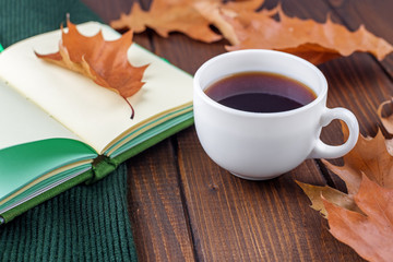 A cup of hot strong coffee and a book. The concept of autumn, still life, relaxation