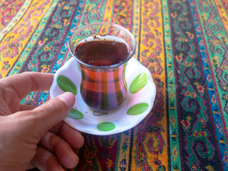 Lady holding hot tea drink in hand