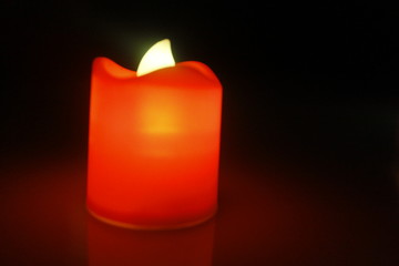 red candle on black background