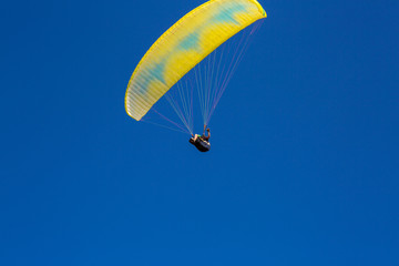 paraglider flying in the blue sky. Paragliding