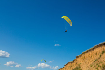 paraglider flying in the blue sky. Paragliding